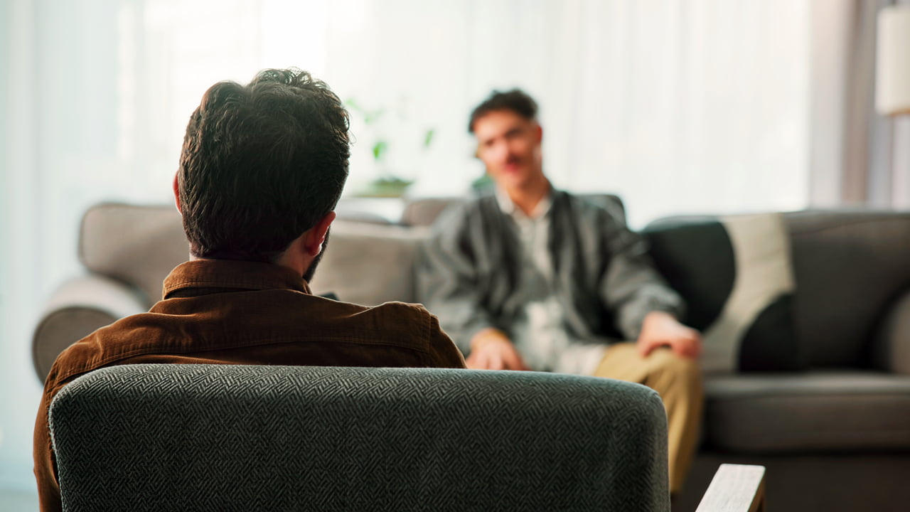 A man in a therapy session with a counselor.